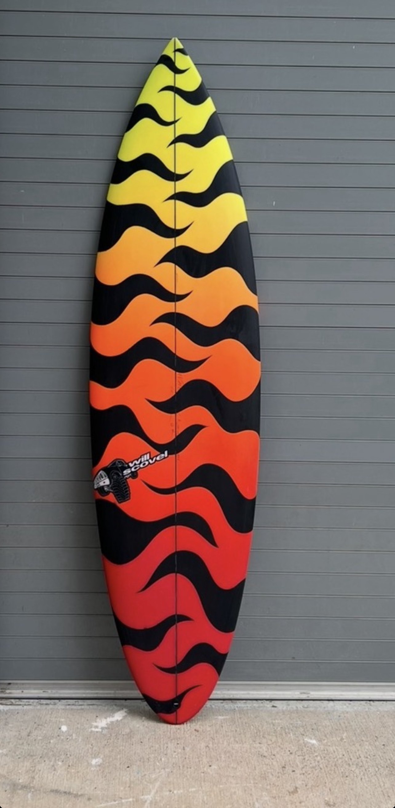 Scovel shortboard with a red, orange and yellow flame fade spray