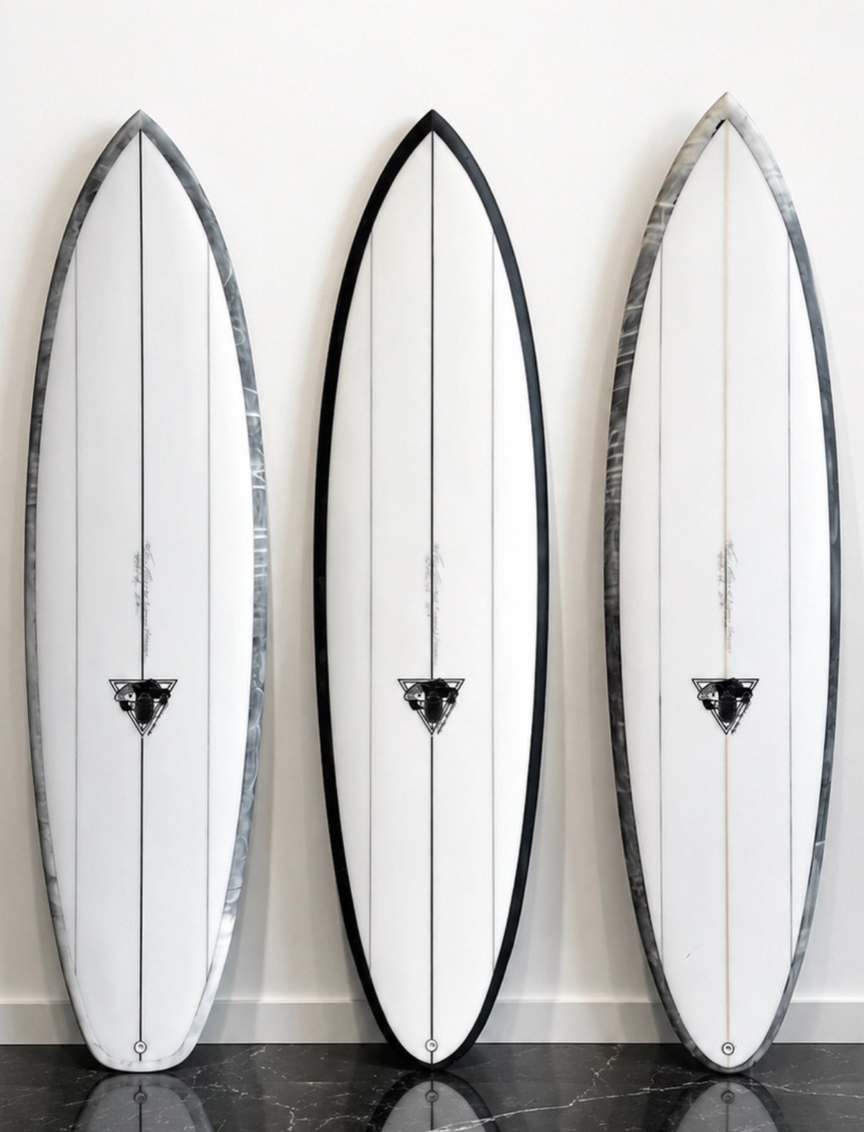 Three white Scovel boards with smoked black and grey resin rails