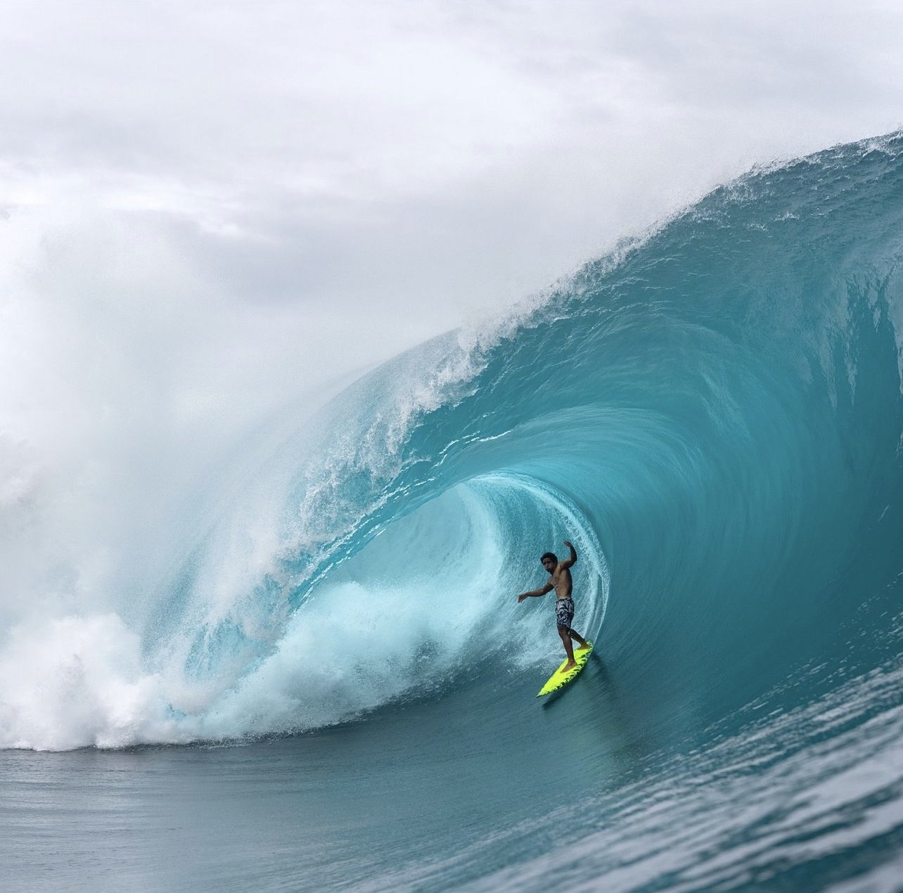 A surfer deep inside a large barreling wave